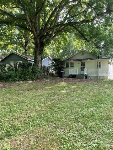 a house that has a tree in front of it