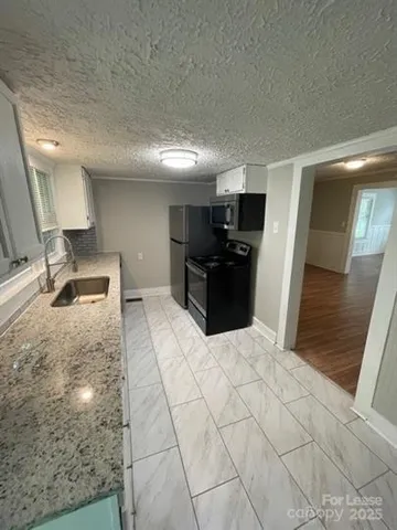 a large bedroom with a bed and a television in it