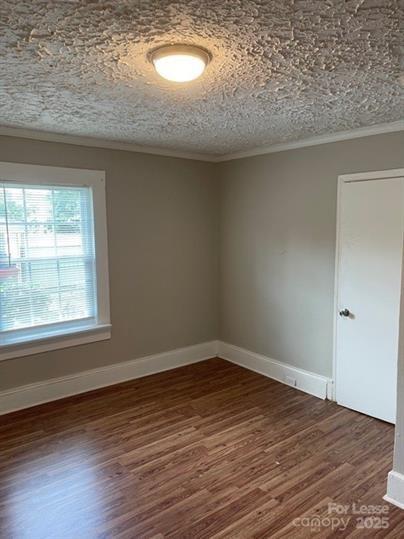 1036 Ridge Avenue Gastonia, NC 28052 - Photo 9 of 11 an empty room with wooden floor and windows