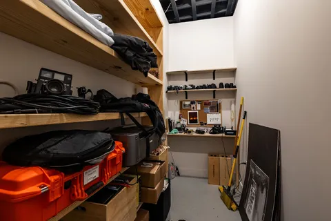 a view of walk in closet with clothes and shoes