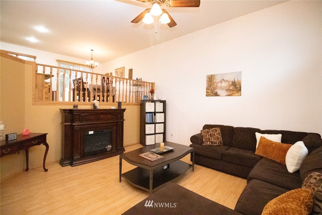214 Fern Meadows Loop Southeast Port Orchard, WA 98366 - Photo 2 of 23 a living room with furniture and a flat screen tv