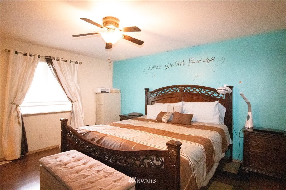 214 Fern Meadows Loop Southeast Port Orchard, WA 98366 - Photo 11 of 23 a bedroom with a bed and wooden floor