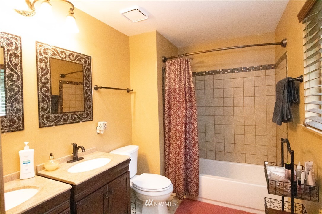 214 Fern Meadows Loop Southeast Port Orchard, WA 98366 - Photo 12 of 23 a bathroom with a sink mirror toilet and bathtub