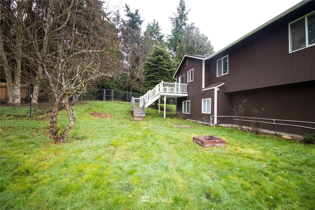 214 Fern Meadows Loop Southeast Port Orchard, WA 98366 - Photo 18 of 23 a view of a house with backyard and a tree