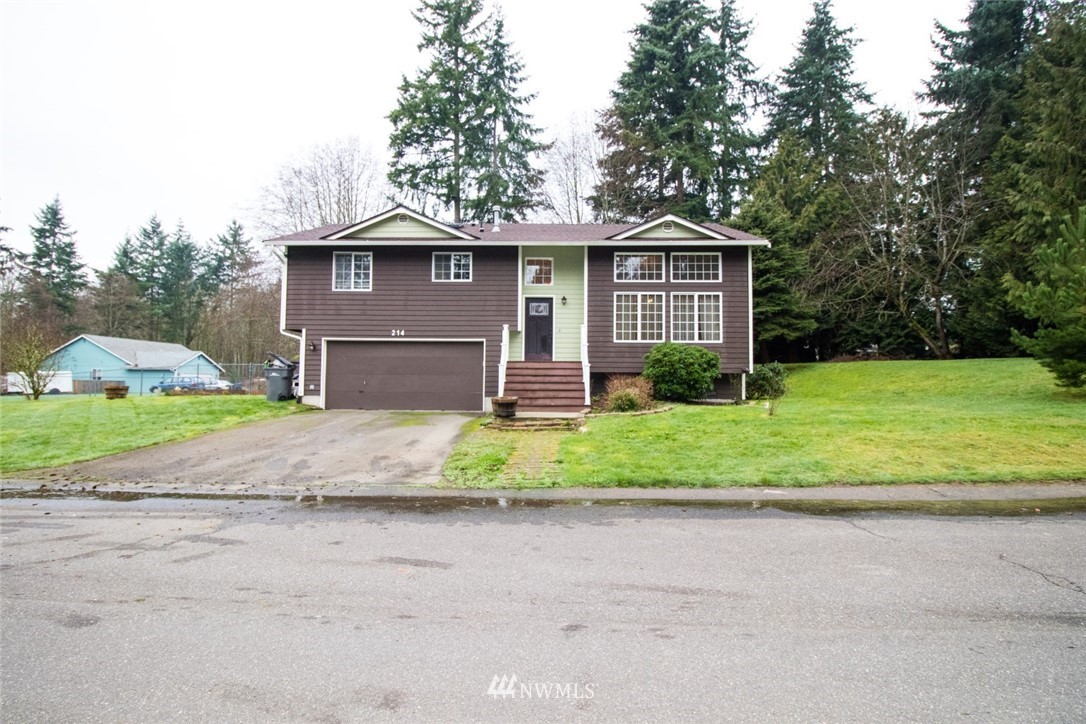 214 Fern Meadows Loop Southeast Port Orchard, WA 98366 - Photo 23 of 23 a front view of a house with a yard and garage