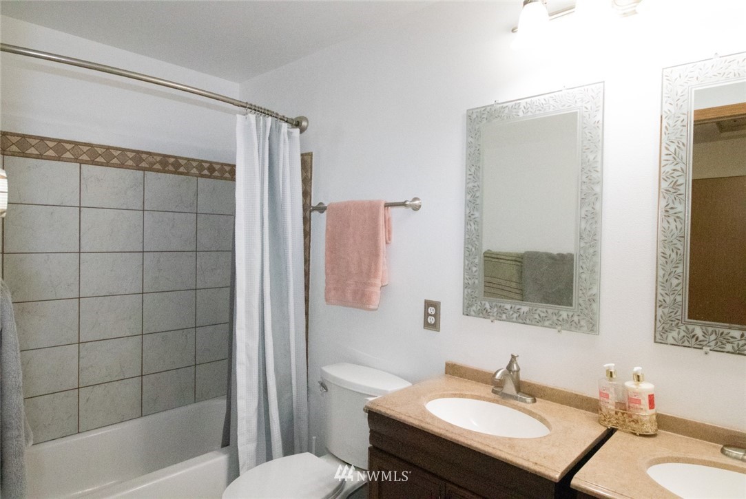 214 Fern Meadows Loop Southeast Port Orchard, WA 98366 - Photo 10 of 23 a bathroom with a sink toilet a mirror and shower