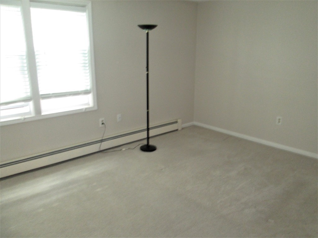32 Lantern Lane, Unit 8 Dracut, MA 01826 - Photo 13 of 14 a view of an empty room with a window