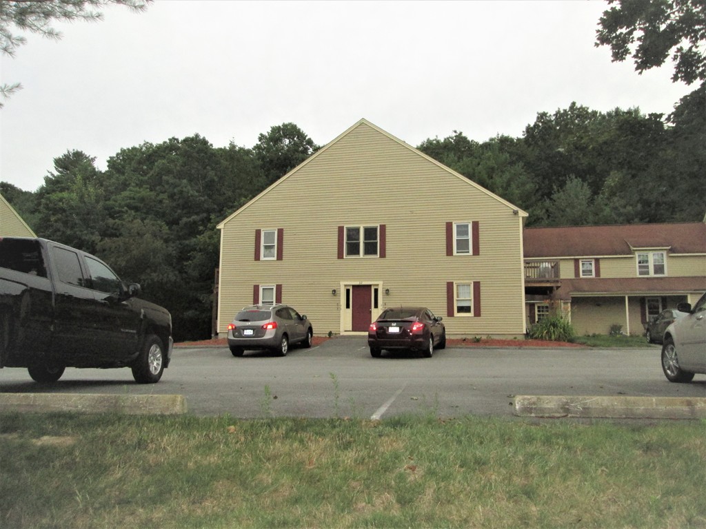 32 Lantern Lane, Unit 8 Dracut, MA 01826 - Photo 2 of 14 a view of a car parked in front of a house