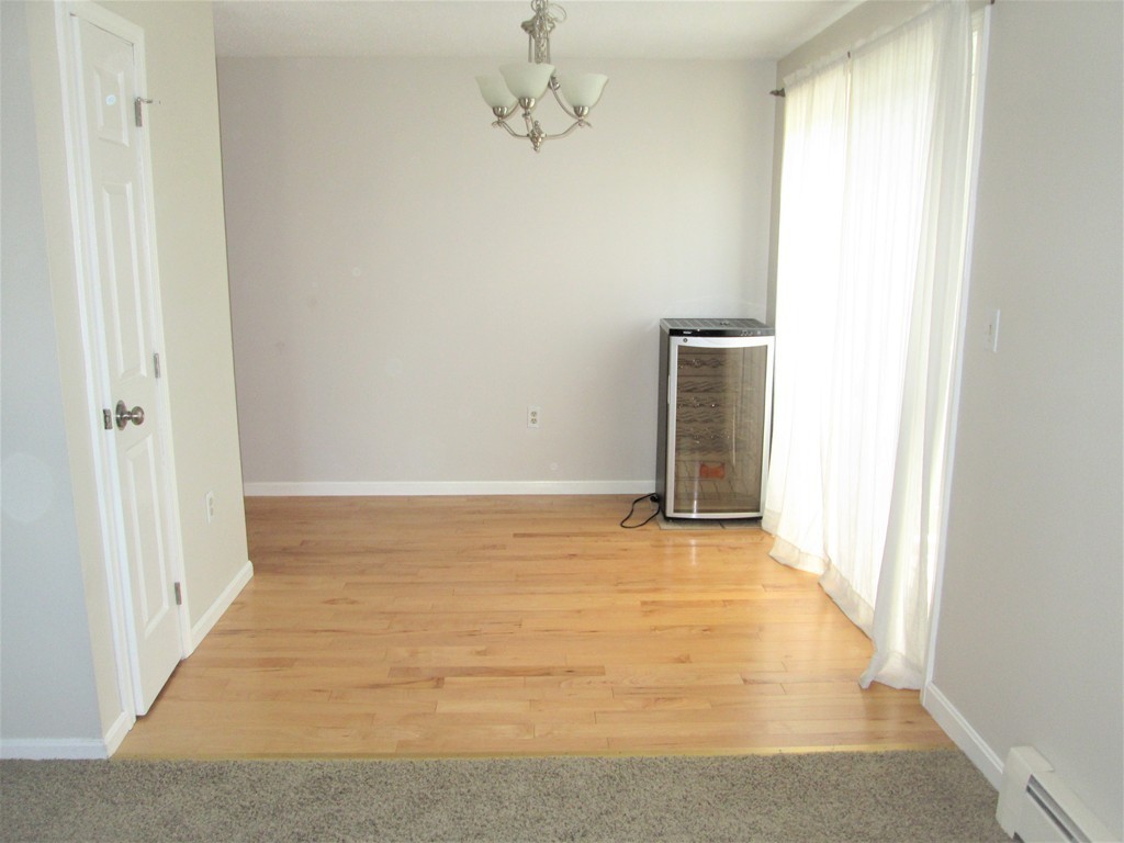 32 Lantern Lane, Unit 8 Dracut, MA 01826 - Photo 7 of 14 an empty room with windows
