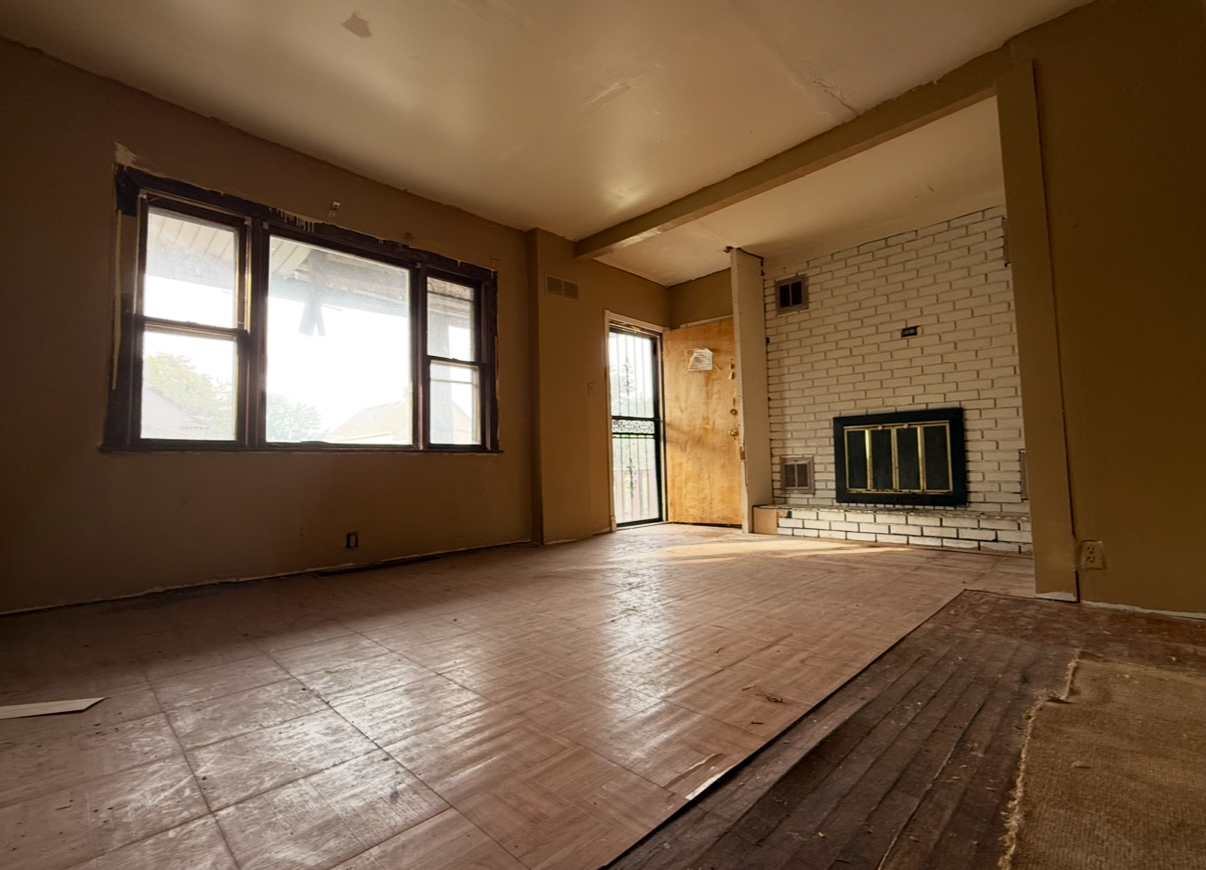 28 156th Street Calumet City, IL 60409 - Photo 2 of 24 a view of an empty room with a fireplace and a window