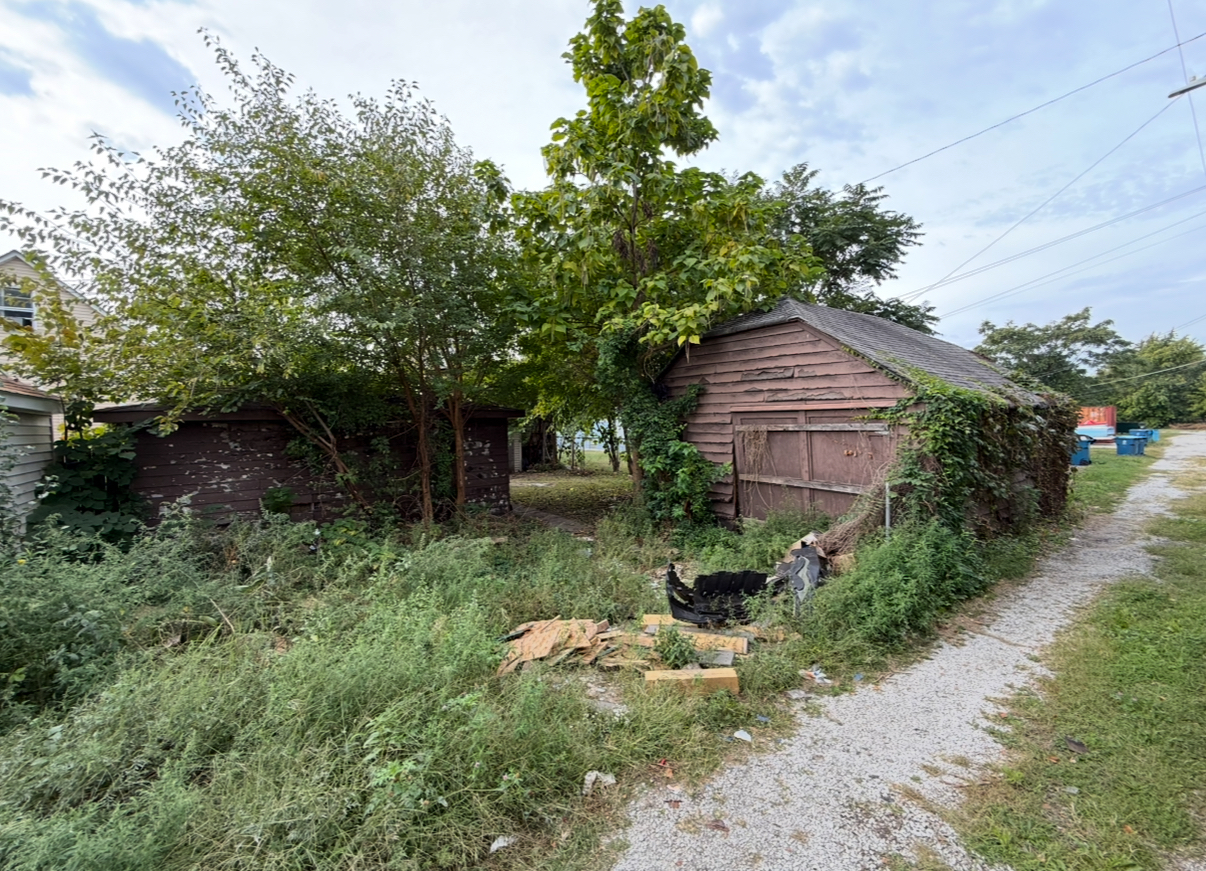 28 156th Street Calumet City, IL 60409 - Photo 22 of 24 a view of a house with a yard plants and large tree