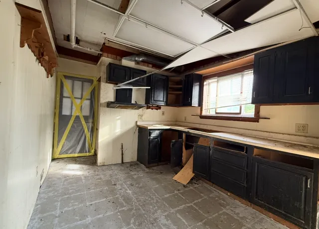 a kitchen with a sink cabinets and window