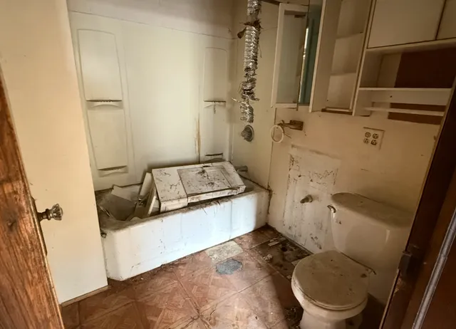 a bathroom with a granite countertop toilet sink and shower