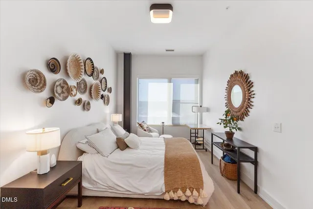 a bedroom with a bed and a chandelier