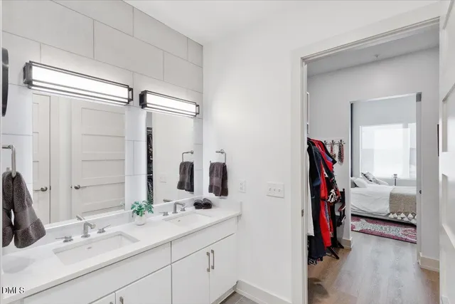 a bathroom with a double vanity sink and a mirror