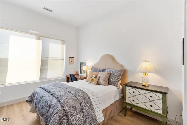 a bedroom with a bed and a lamp