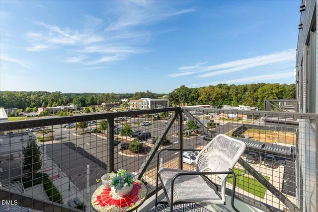 a view of a balcony with chairs and wooden floor