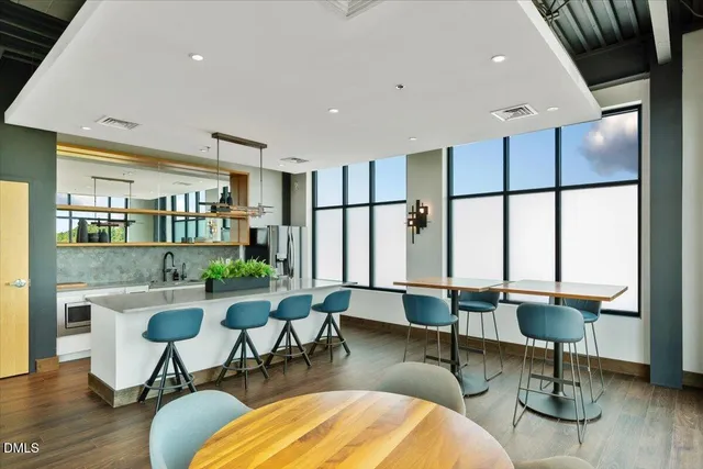 a living room with furniture wooden floor and a table