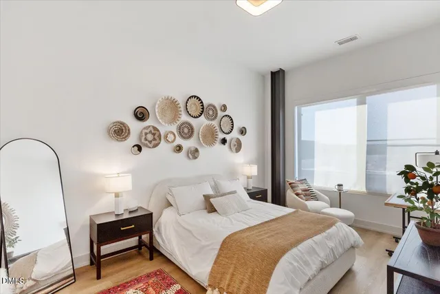 a bedroom with a bed and a window