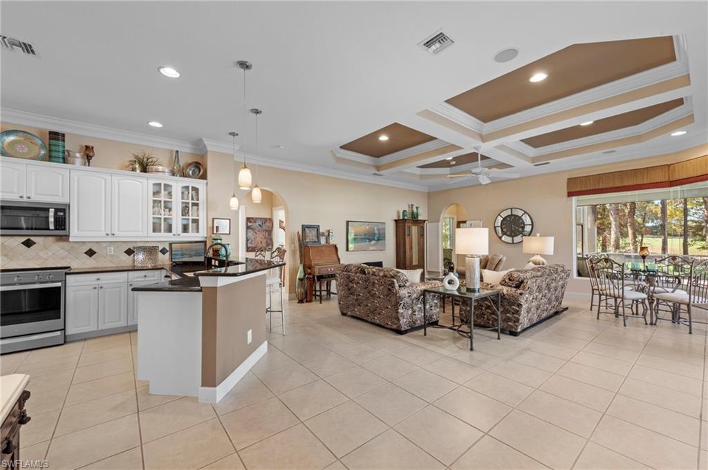 20042 Buttermere Court Estero, FL 33928 - Photo 11 of 47 a large room with kitchen island granite countertop lots of white stainless steel appliances