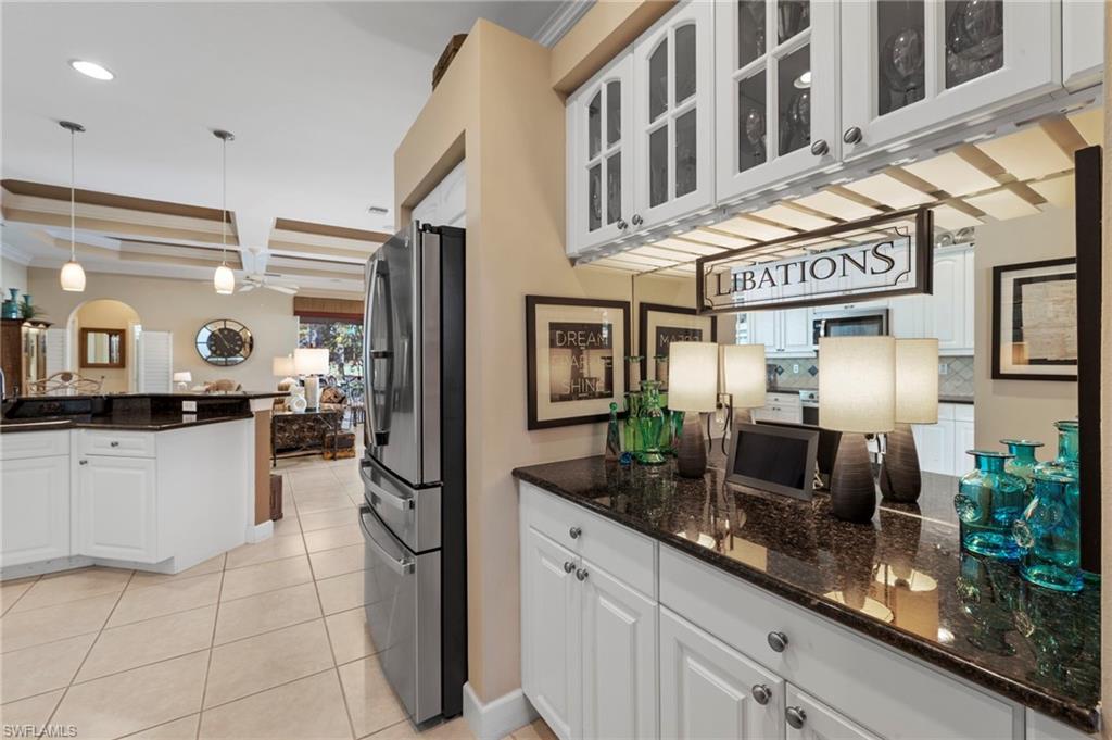 20042 Buttermere Court Estero, FL 33928 - Photo 13 of 47 a kitchen with stainless steel appliances granite countertop a sink and a refrigerator