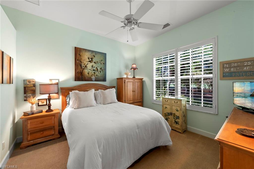 20042 Buttermere Court Estero, FL 33928 - Photo 26 of 47 a bedroom with a bed and a couch