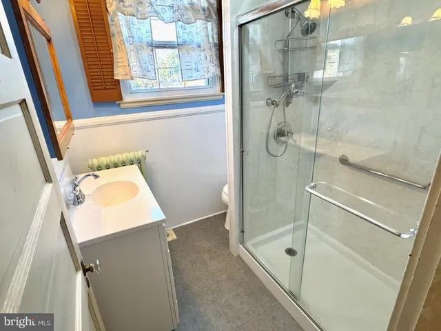 a bathroom with a shower and a sink