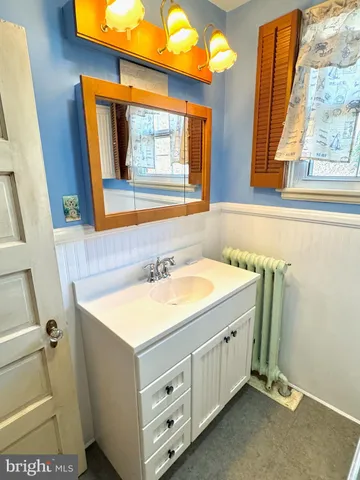 a bathroom with a sink vanity and a mirror