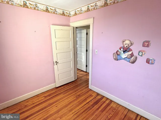 a view of a room with wooden floor