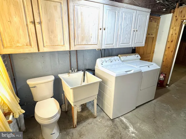 a bathroom with a toilet a sink and a window