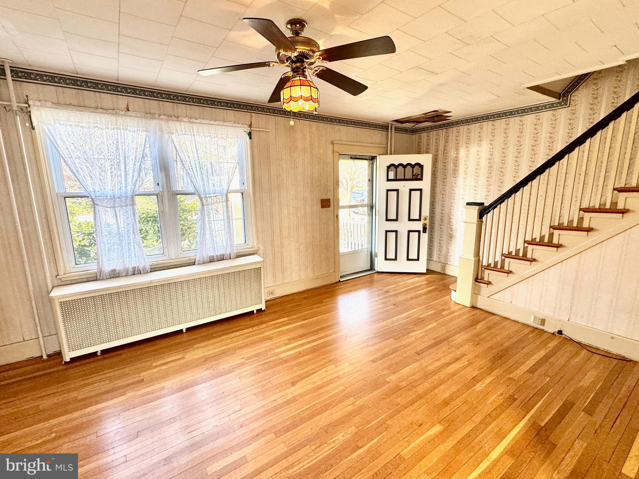 331 Sunset Road Reading, PA 19611 - Photo 3 of 32 a view of an empty room with wooden floor and a window