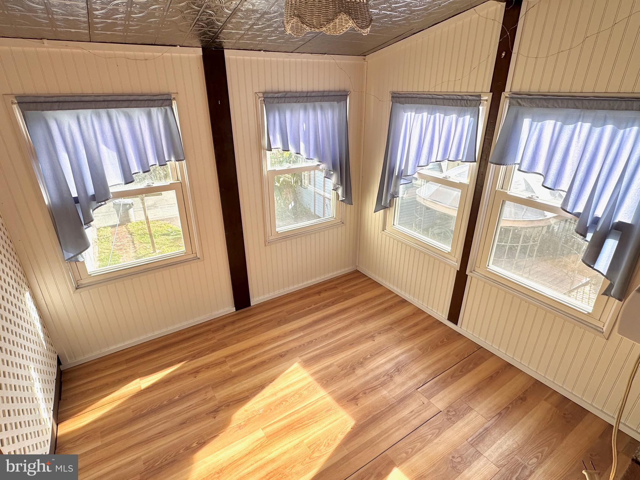 331 Sunset Road Reading, PA 19611 - Photo 10 of 32 a view of an empty room with wooden floor and a window