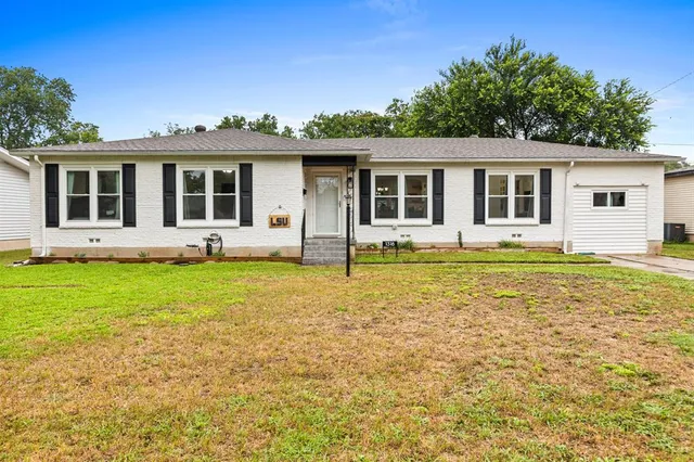 a front view of house with yard and green space