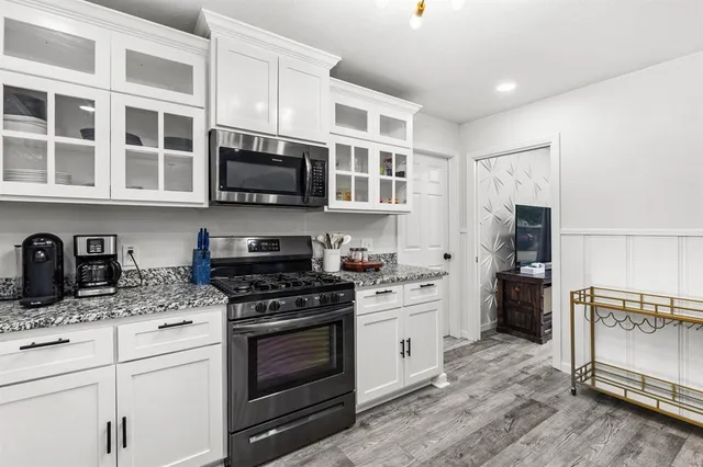 a kitchen with stainless steel appliances granite countertop a stove and a sink