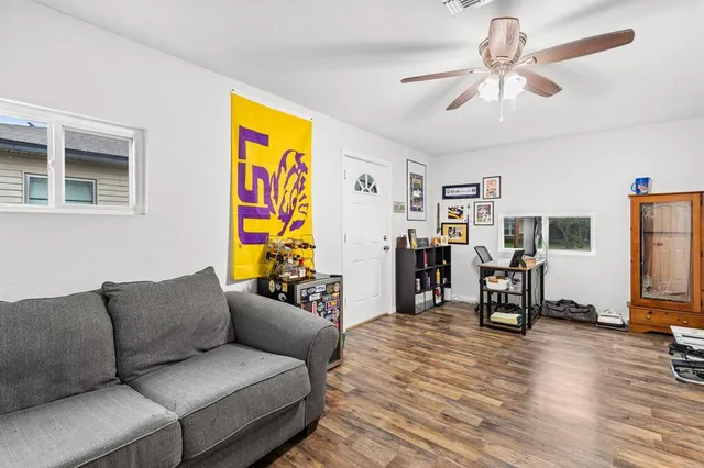 a living room with furniture and wooden floor