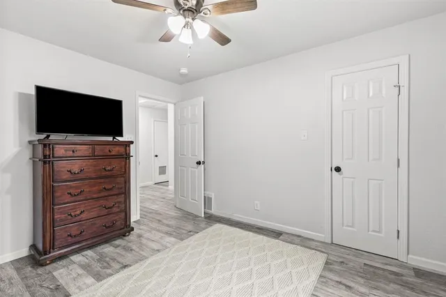 a room with a television and a dresser