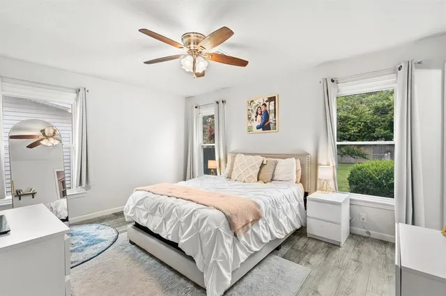 a bedroom with a large bed and a window