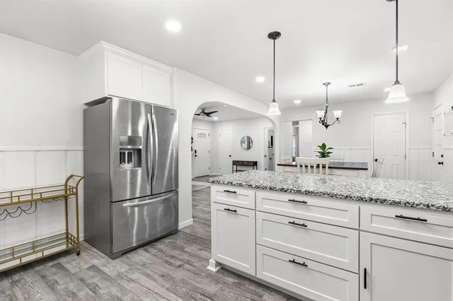 a kitchen with center island and stainless steel appliances