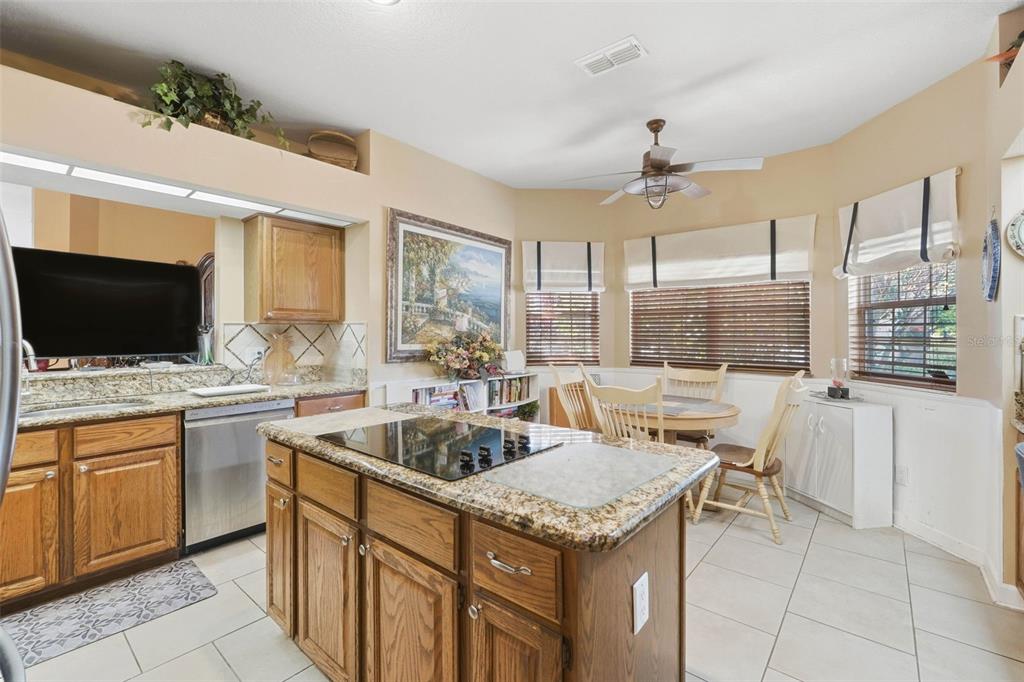 4870 Watervista Drive Orlando, FL 32821 - Photo 12 of 36 a kitchen with a stove sink and microwave