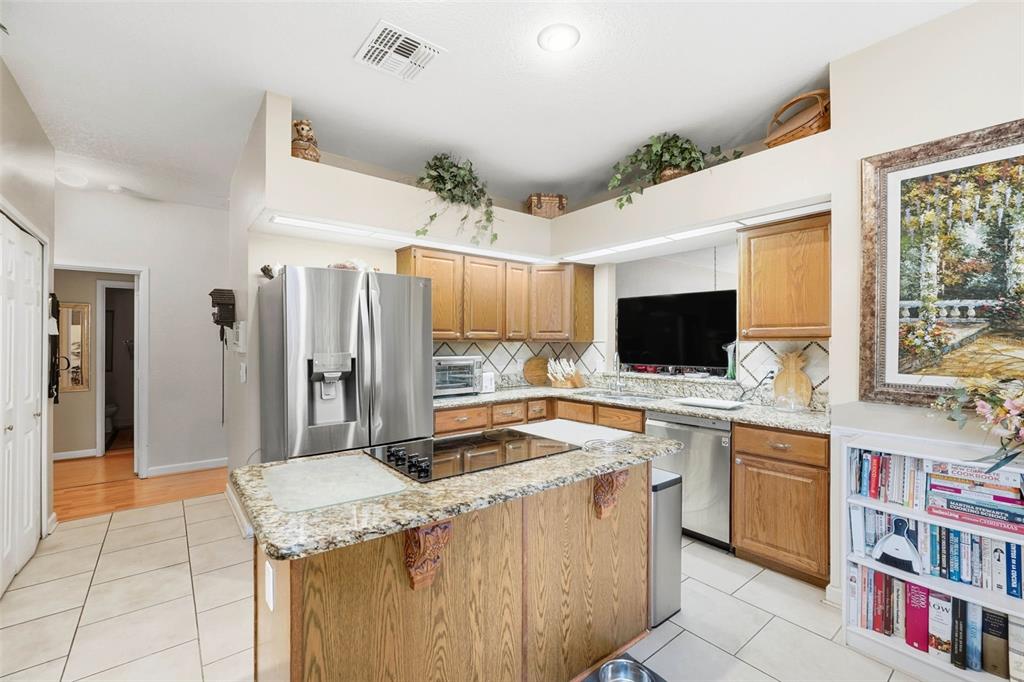 4870 Watervista Drive Orlando, FL 32821 - Photo 15 of 36 a kitchen with a sink stove and cabinets