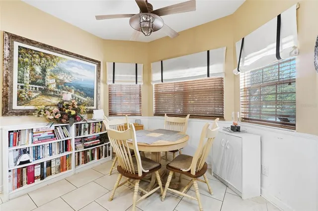 a dining room with furniture a book shelves and wooden floor