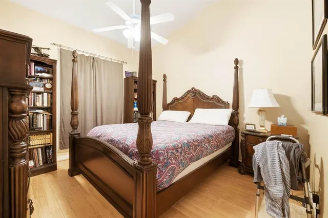 a bedroom with a bed next to a window