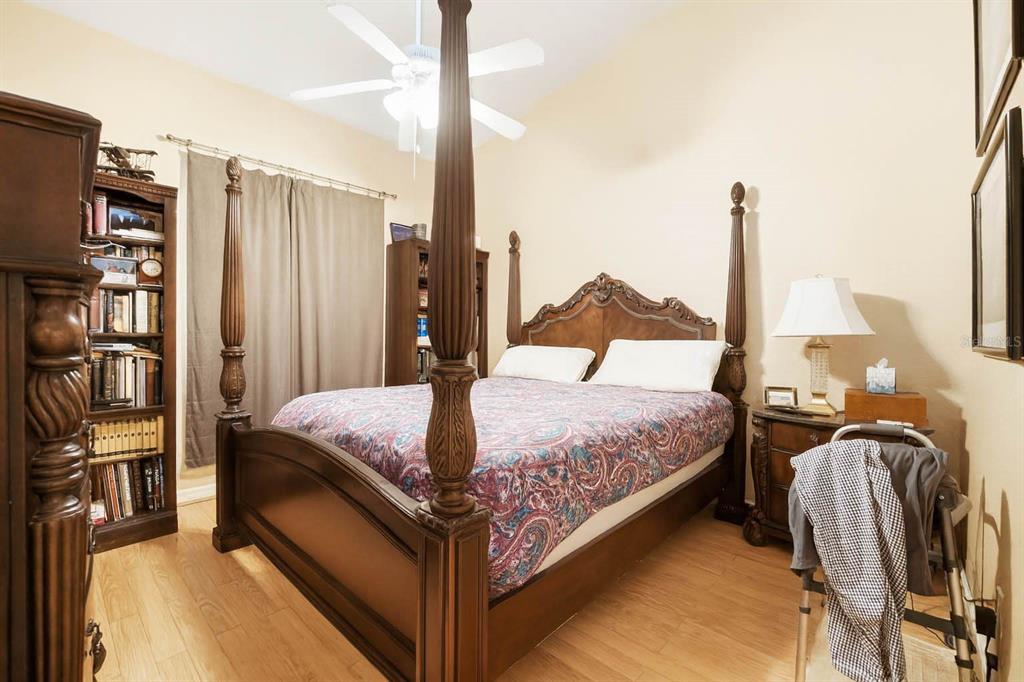 4870 Watervista Drive Orlando, FL 32821 - Photo 18 of 36 a bedroom with a bed next to a window