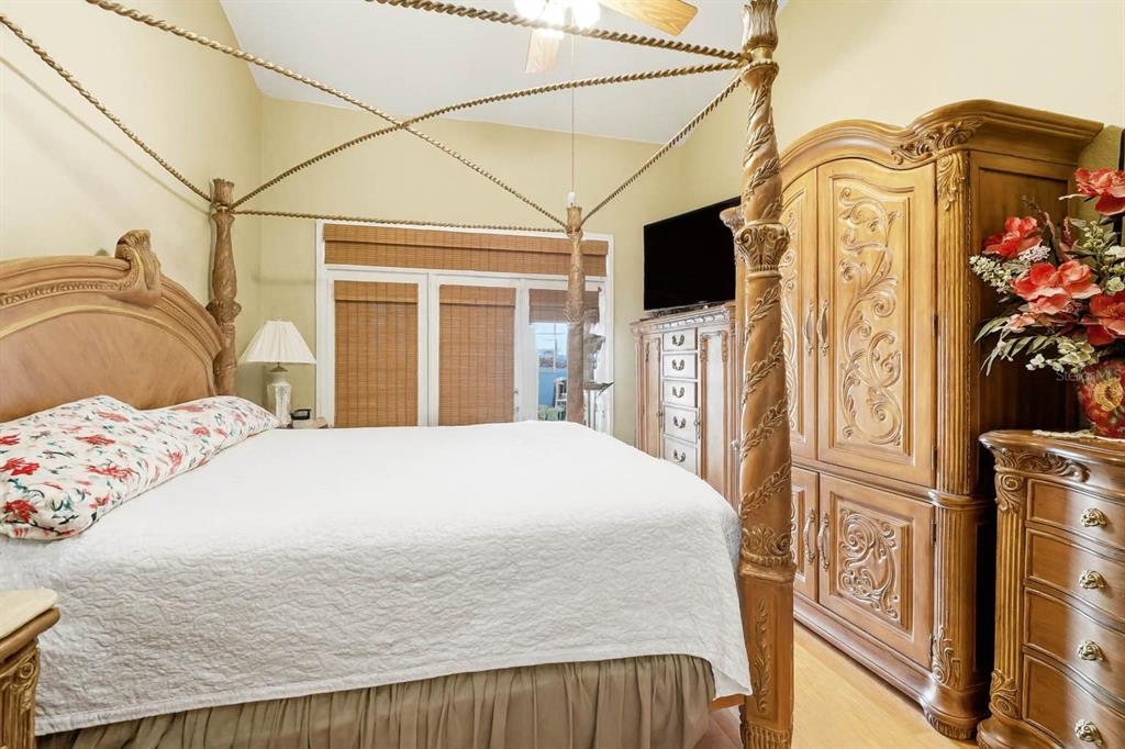 4870 Watervista Drive Orlando, FL 32821 - Photo 20 of 36 a bedroom with a bed a flat screen tv and dresser