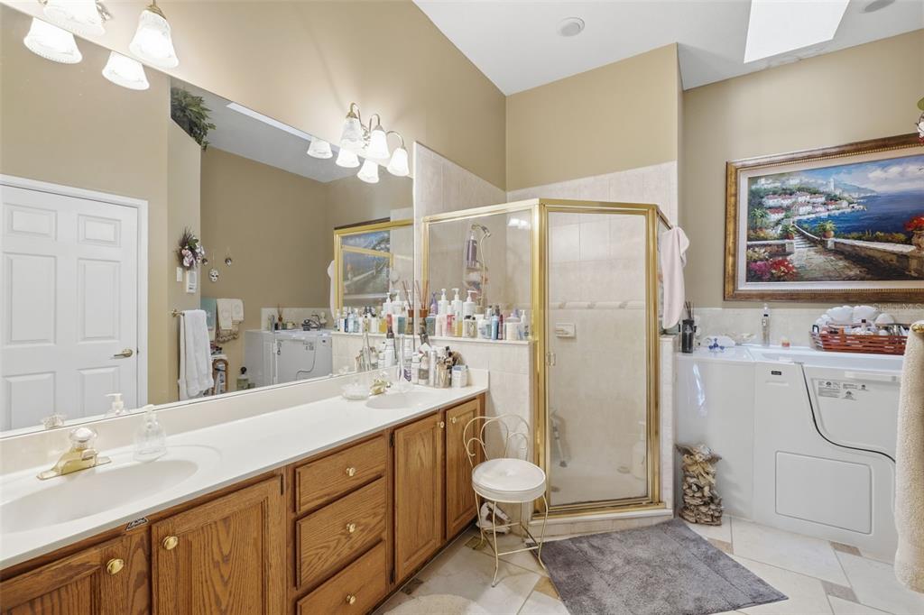 4870 Watervista Drive Orlando, FL 32821 - Photo 21 of 36 a bathroom with a double vanity sink mirror and toilet