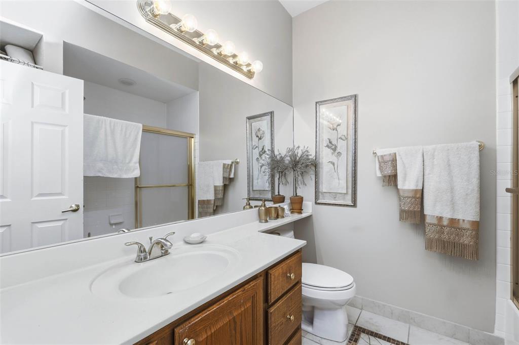 4870 Watervista Drive Orlando, FL 32821 - Photo 23 of 36 a bathroom with a sink toilet and shower