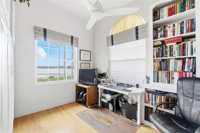 a workspace with furniture bookshelf and a window