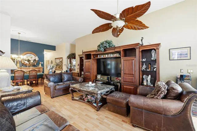 a living room with furniture ceiling fan and a rug