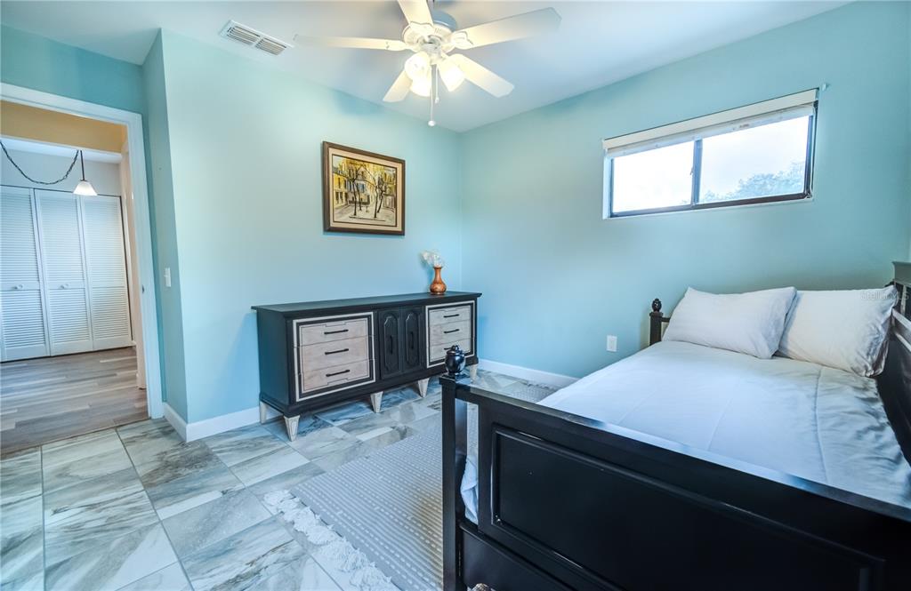 600 Carriage House Lane, Unit 201 Nokomis, FL 34275 - Photo 16 of 23 a bedroom with a bed and a tv