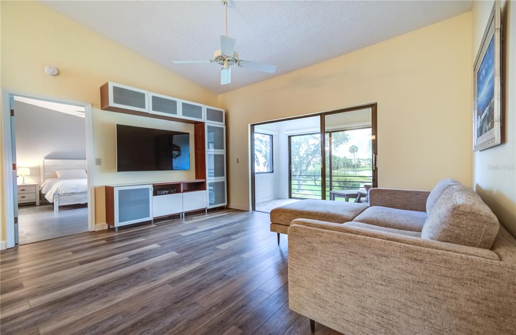 600 Carriage House Lane, Unit 201 Nokomis, FL 34275 - Photo 3 of 23 a living room with furniture and a flat screen tv